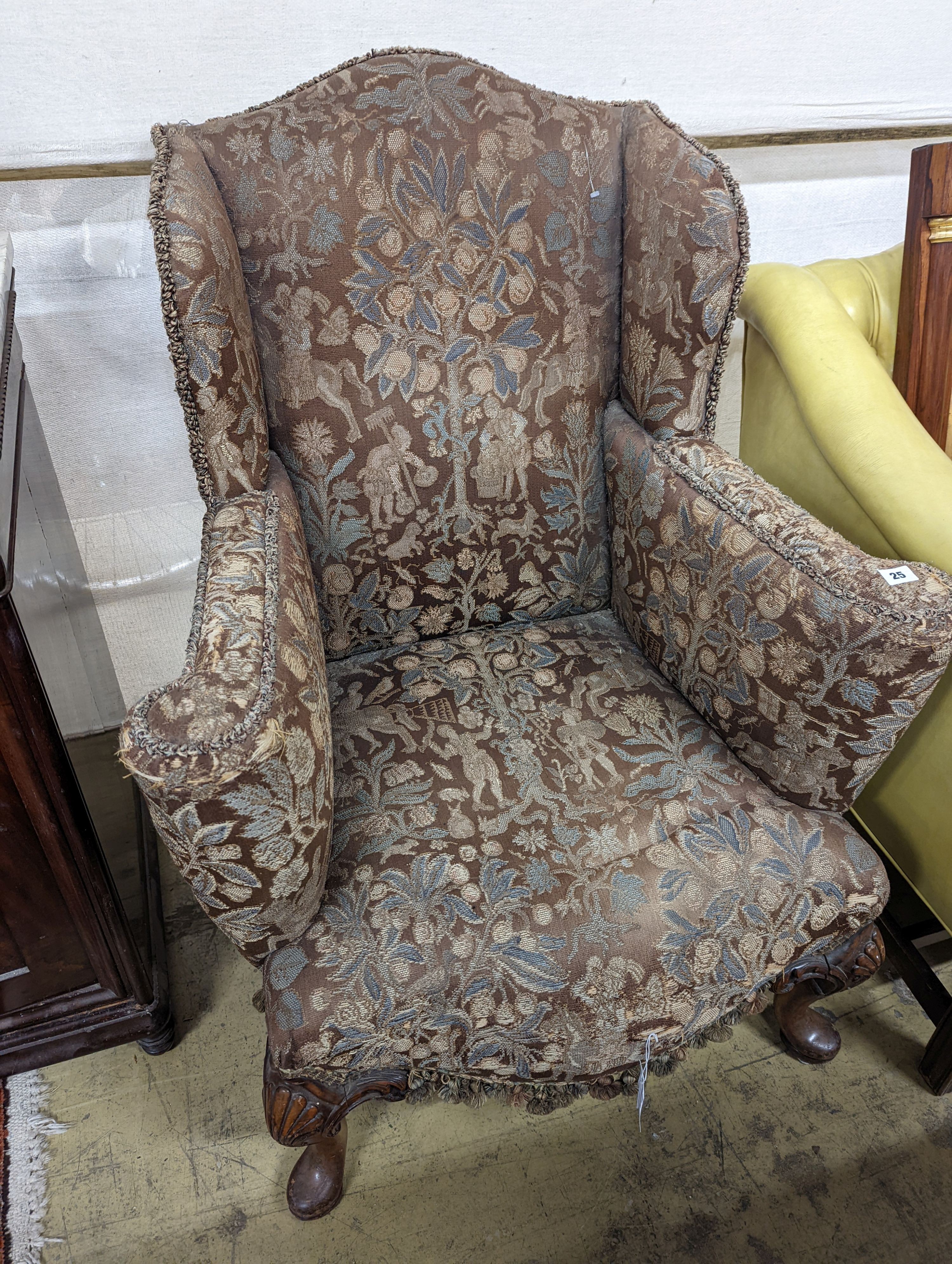 A Queen Anne revival upholstered walnut wing armchair, width 78cm, depth 78cm, height 96cm